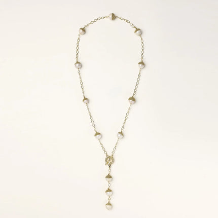 Gold-plated lariat necklace with baroque pearls and textured caps on cream background, showing adjustable Y-shaped design.