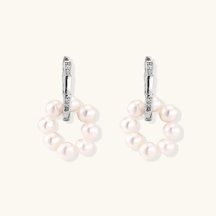 Rhodium-plated silver hoop earrings with freshwater pearls arranged in crescent formation and diamond accents