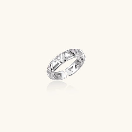 White gold adjustable ring with geometric triangle cutouts and zirconia stones on cream background