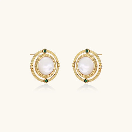 Circular gold stud earrings with iridescent mother-of-pearl center and green zirconia accents on cream background.