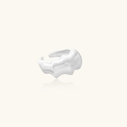 Brushed sterling silver ring with organic wave-like edges and adjustable cuff design on white background