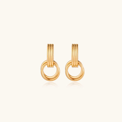 Gold stud earrings with vertical ridged bar connecting to triple interlocking circular rings on white background