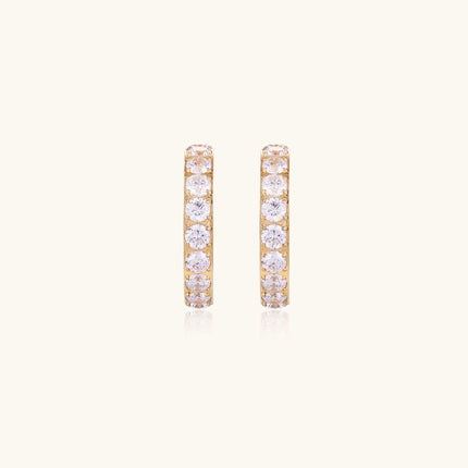 Gold pavé hoop earrings with two freshwater pearls nestled inside the curved design, featuring crystal-studded outer edge.