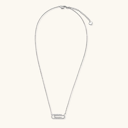 White gold plated necklace with dual-frame geometric pendant featuring crystal pavé border on pale background.