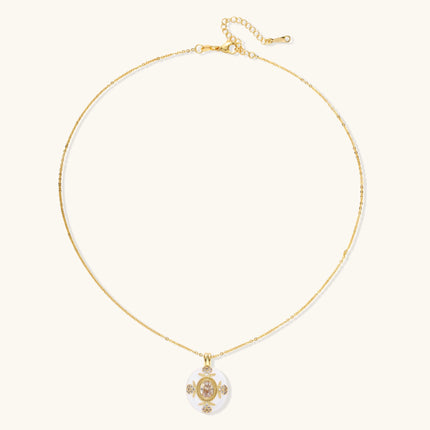 Gold-plated necklace with circular white enamel pendant featuring central zirconia stone and ornate decorative details