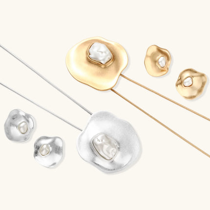 Organic-shaped eco-zinc alloy stud earrings with resin pearl centers and sterling silver posts on white background.