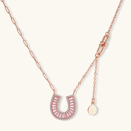 Sparkling horseshoe-shaped jewelry set with AAA cubic zirconia in gold-plated and white gold finishes on cream background.