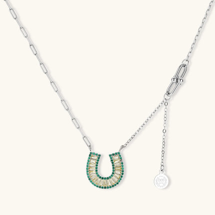 Sparkling horseshoe-shaped jewelry set with AAA cubic zirconia in gold-plated and white gold finishes on cream background.